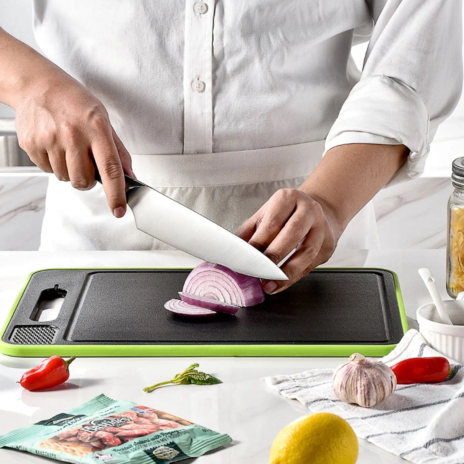 Cutting board with diced tomatoes, being held in hand.