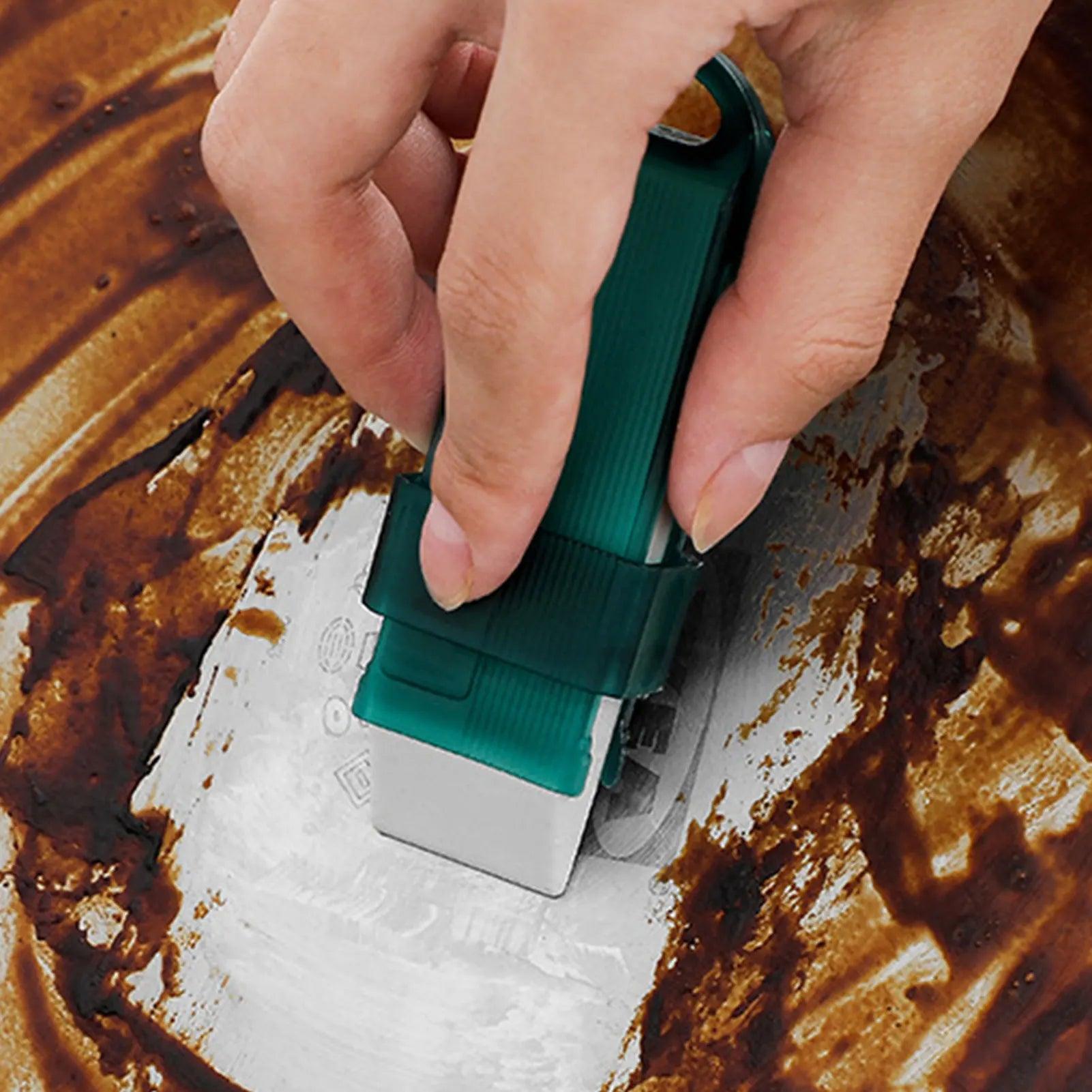 All-Purpose Cleaning Tool - Scrubbing a greasy pan with the green eraser.