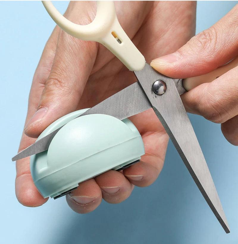 Blade Boost Mini Knife Sharpener - Blue compact knife sharpening tool used on scissors.