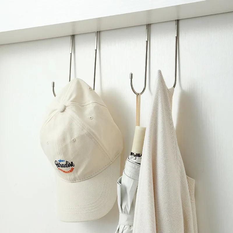 Space-Saving Double Hooks organizing clothes and umbrella in a closet.