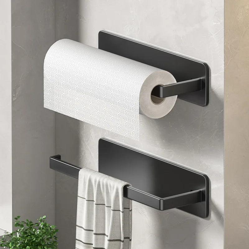 Wall-mounted Black kitchen racks holding a paper towel roll.