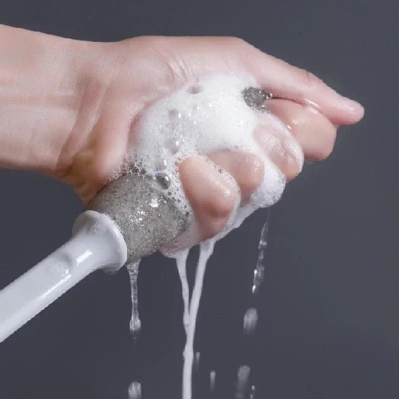 Versatile bottle cleaning brush being rinsed under running water.